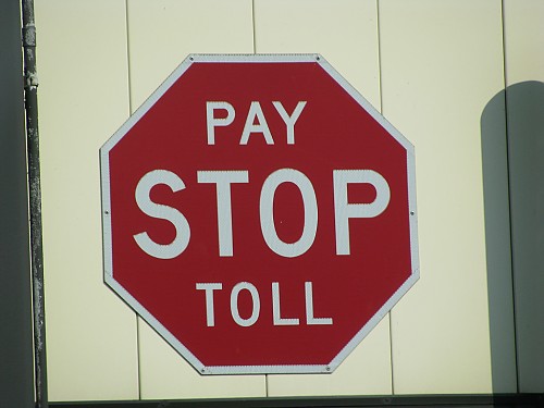 stop sign that says stop pay toll